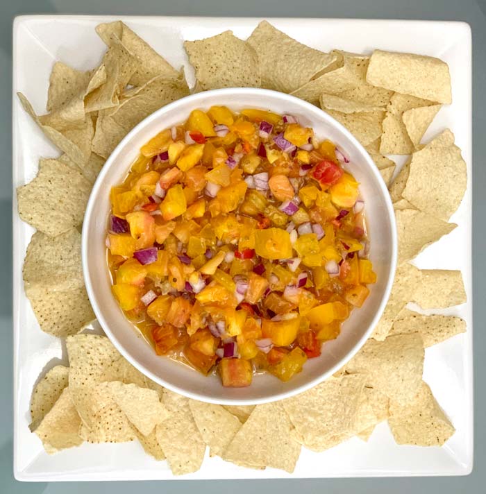 Pico de gallo - perfect as a standalone dish with tortilla chips or added to tacos, quesadillas, or other Latin American cuisine.